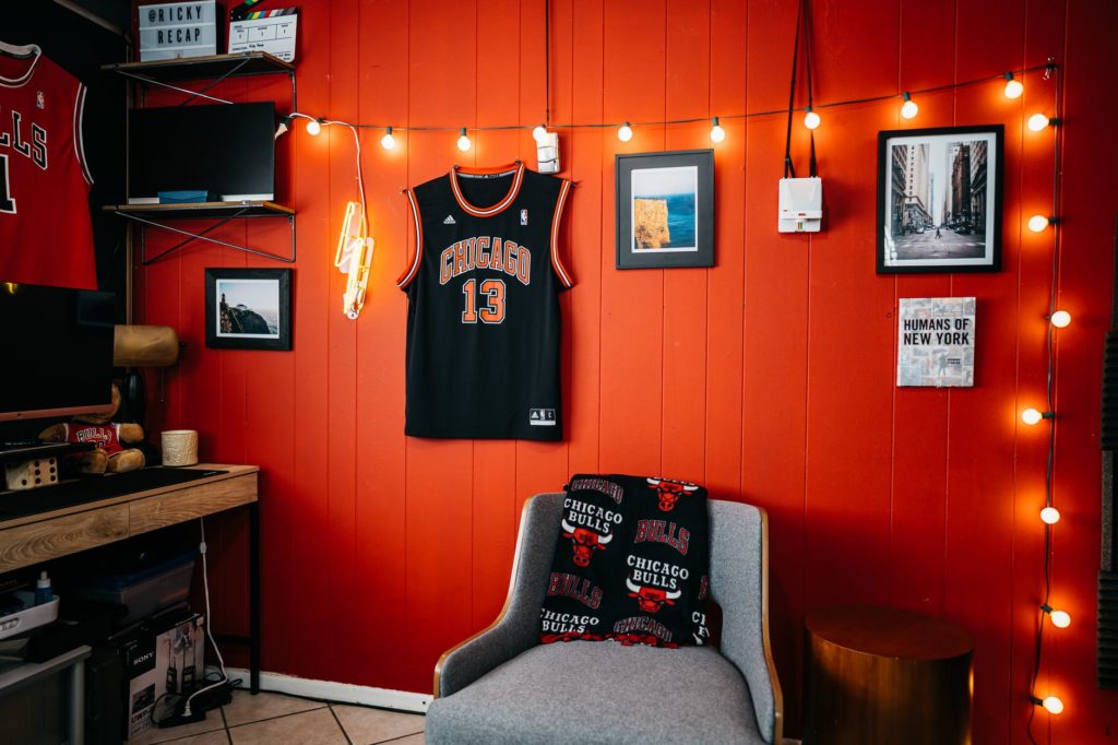 black and white jersey shirt on red wall